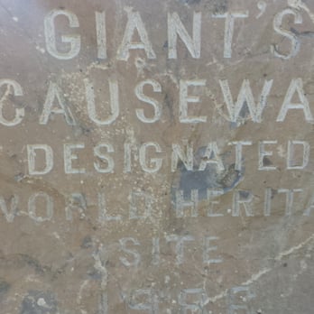 The Giant's Causeway - "GIANT CAUSEWAY" stone sign at the entrance. - Beaches Near Me - Ireland, ORK