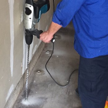 Mills Pest Management - Drilling through the concrete slab in the garage to treat for subterranean termites. - Pest Control Near Me - Burbank, California