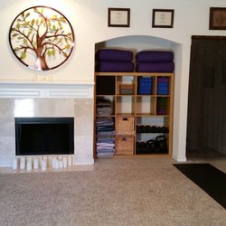 The cubby holds several bolsters, blocks, blankets, straps, and other supportive props that help with various adaptations.