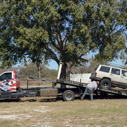 JT'S Towing & Wrecker Service - Vehicle on a towing truck trailer