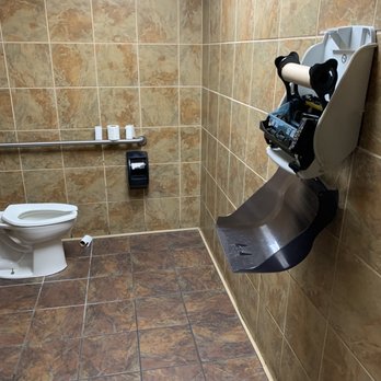 Taco Bueno - a public restroom with a toilet and sink - Mexican Near Me - Shawnee, Oklahoma