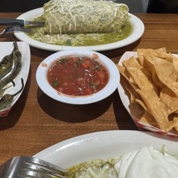 Complimentary chips and salsa and super burrito wet with pastor Complimentary chips and salsa and super burrito wet with pastor