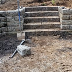 Green Triangle Landscaping - Installing steps with retaining wall.