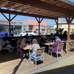 Bua Luang - Patio area seating in the sunny day. Perfect for dining and drinking.