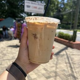 Iced Oatmilk  latte with cinnamon powder