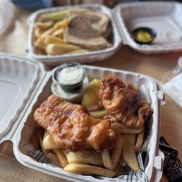 Fish and chips and turkey on rye in the background. Fish and chips and turkey on rye in the background.