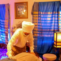 The Khalsa Healing Arts & Yoga Center - Dr Khalsa doing cranio-sacral adjustment in their amethyst crystal healing room