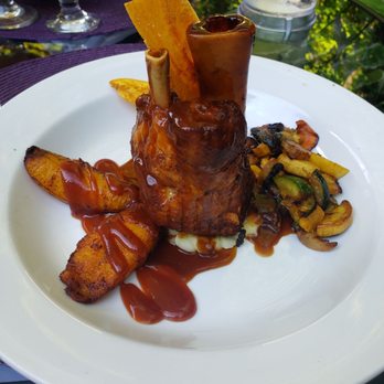 Melaza Bistro - Pork Shank with Guava Sauce, Vegetables, and Plantains - Tapas/Small Plates Near Me - Woodstock, Vermont Melaza Bistro - Pork Shank with Guava Sauce, Vegetables, and Plantains - Tapas/Small Plates Near Me - Woodstock, Vermont