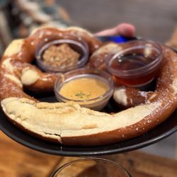 Edelweiss Pizza Pub Pastries - Huge pretzel with array of sauces.