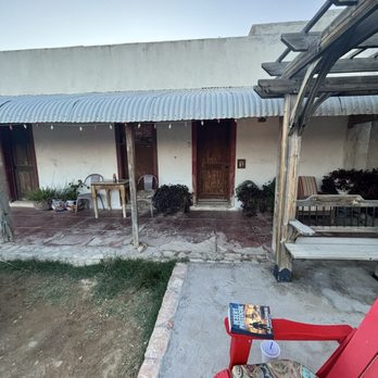 Big Bend Holiday Hotel - Perfect room in the corner with a grill, chairs and a water fountain - Hotels Near Me - Terlingua, Texas