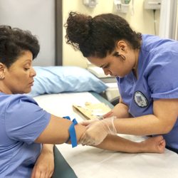 AIMS Education College of Health Sciences - Medical Assistant students drawing blood.