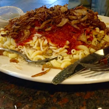 La Marsa - Brighton - Kosher, a large plate loaded with pasta, rice, lentils, tomato sauce and topped with crunchy fried onions. - Middle Eastern Near Me - Brighton, Michigan