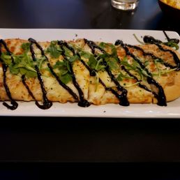 a flatbread pizza on a plate a flatbread pizza on a plate