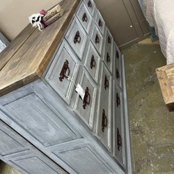 Rustic Furniture Warehouse Sales - Distressed gray dresser with a natural wood top and dark hardware. Generous drawer space combines everyday function with rustic character.