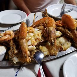 Seafood dinner for three on our last night in Brazil. Shrimp on top, lobster, octopus, whitefish, rice and more. Seafood dinner for three on our last night in Brazil. Shrimp on top, lobster, octopus, whitefish, rice and more.