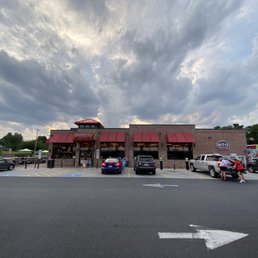 a parking lot with cars parked in front of a restaurant
