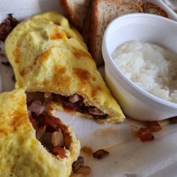 Huddle House - Omelet meat lover's cut into , grits and wheat toast