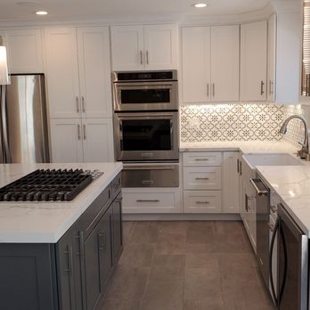 Rommy's Kitchen & Closets by Design - a kitchen with white cabinets and marble countertops - General Contractors Near Me - Chula Vista, California