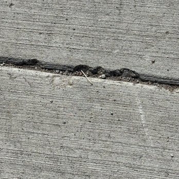 Rock Solid Construction - Cracking sidewalk.  It's chipping off. - Masonry/Concrete Near Me