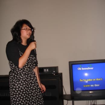Seattle's Best Karaoke - a woman standing in front of a tv - Karaoke Near Me - Seattle, Washington Seattle's Best Karaoke - a woman standing in front of a tv - Karaoke Near Me - Seattle, Washington
