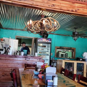 Log Cabin Restaurant - Inside with antler light fixture and tin ceiling. - American Near Me - Ellsinore, Missouri Log Cabin Restaurant - Inside with antler light fixture and tin ceiling. - American Near Me - Ellsinore, Missouri