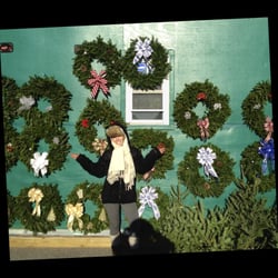 Uncle Steve's Christmas Trees - Kelly, our Master Wreath Maker, with some of her handmade Christmas wreaths.