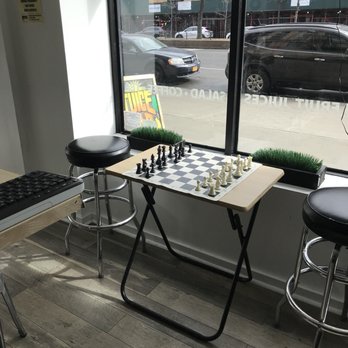 Uptown Juice Bar - Chessboard set up by the window - Juice Bars & Smoothies Near Me - New York, New York
