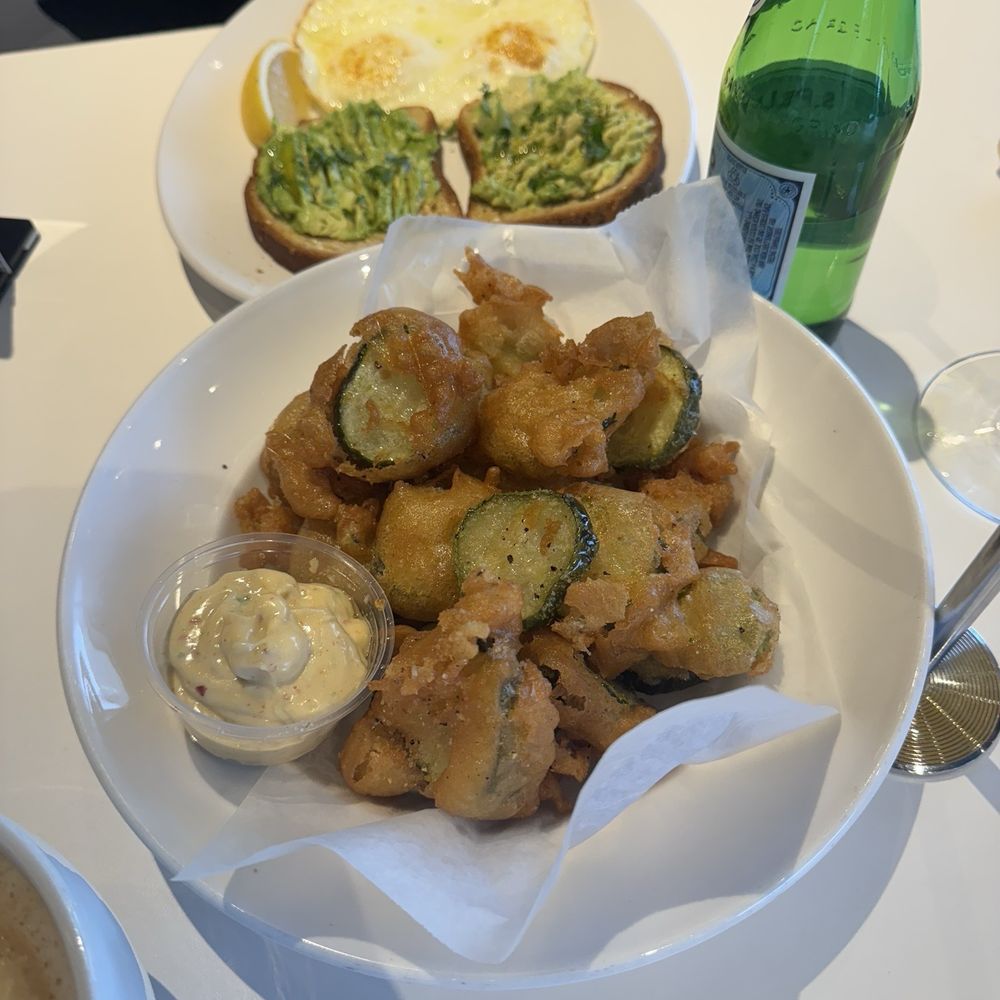 Mustard Seed Cafe - Special of gluten free tempura fried pickles with kimchi truffle aioli and avocado toast with eggs in the background - Cafes Near Me - Akron, Ohio Mustard Seed Cafe - Special of gluten free tempura fried pickles with kimchi truffle aioli and avocado toast with eggs in the background - Cafes Near Me - Akron, Ohio