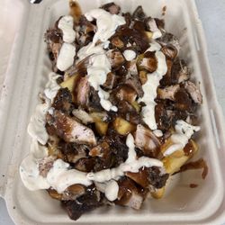 Chef Irie's Jamaican Kitchen - Big Up Loaded Fries: Fries topped with a whole piece of jerk chicken, cheese, Chef's jerk sauce, and our house-blend ranch.