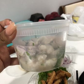 Sol Inca - a hand holding a plastic container filled with food - Peruvian Near Me - Jackson Heights, New York Sol Inca - a hand holding a plastic container filled with food - Peruvian Near Me - Jackson Heights, New York