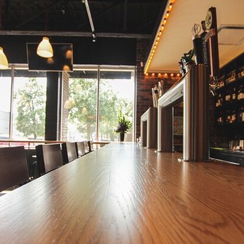 Esca Gourmet Pizza + Bar - a long wooden table - Pizza Near Me - Cornwall, Ontario Esca Gourmet Pizza + Bar - a long wooden table - Pizza Near Me - Cornwall, Ontario