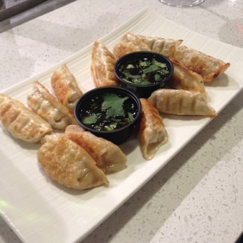 Chefs At Your Home - a plate of dumplings and dipping sauce - Personal Chefs Near Me Chefs At Your Home - a plate of dumplings and dipping sauce - Personal Chefs Near Me