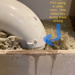 A hole caused by them drilling a drywall screw into pipe. - PVC piping in a utility room has a drilled hole, discovered on 8/16/21, with sheet rocking in progress nearby.