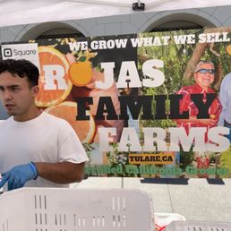 a man standing in front of a sign a man standing in front of a sign