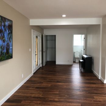 Versatile Construction - an empty hallway with a painting on the wall - General Contractors Near Me