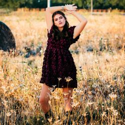 Shani Zreik Photography - This senior chose Prosper High for her senior photos in Prosper, Tx. Her burgundy rosette dress looked stunning in a golden field at sunset.