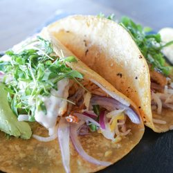 Beeside Balcony - Grilled Rockfish Tacos - sautéed, mango jicama slaw, avocado, lemon remoulade, micro cilantro all on two corn tortillas.