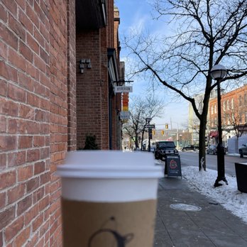 Hyperion Coffee - Ann Arbor - a hand holding a cup of coffee - Coffee Roasteries Near Me - Ann Arbor, Michigan