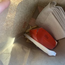 Fries thrown into bag upside down. Fries thrown into bag upside down.