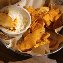 Smokehouse 52 BBQ - Potato chips and dip. High recommended, definitely worth it. A warm cream cheese and onion dip.