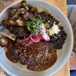 Chicken mole with beans, rice and Brussels sprouts.