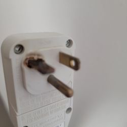 Quality Inn - Plug from air conditioner. Left prong burnt.