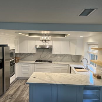 Spgconstruction - a kitchen with white cabinets and marble countertops - General Contractors Near Me Spgconstruction - a kitchen with white cabinets and marble countertops - General Contractors Near Me