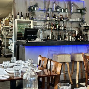 Olove Greek Kitchen - warm and simple, bar, wooden tables, clean place settings - Greek Near Me - Burnaby, British Columbia Olove Greek Kitchen - warm and simple, bar, wooden tables, clean place settings - Greek Near Me - Burnaby, British Columbia