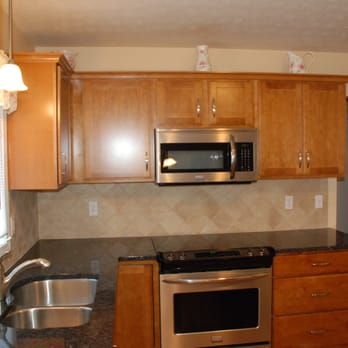 Four Points Remodeling - a kitchen with stainless steel appliances - General Contractors Near Me - Pittsford, New York Four Points Remodeling - a kitchen with stainless steel appliances - General Contractors Near Me - Pittsford, New York