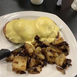 a plate of food with eggs and potatoes