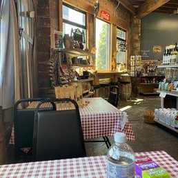 A couple of tables and stools inside to enjoy a quick bite before heading to the coast or back home : ) A couple of tables and stools inside to enjoy a quick bite before heading to the coast or back home : )