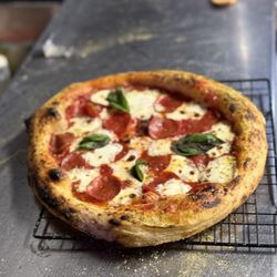 Point of Fire Pizza - Neapolitan style pizza- tomato sauce, mozzarella cheese, pepperoni, hot, honey, drizzle and basil. "The Fughgeddaboudit"