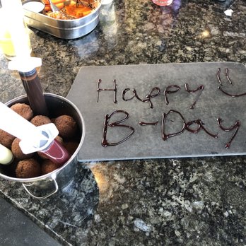 Topgolf - Nice little gesture for a birthday celebration. Doughnut balls with white chocolate, chocolate and strawberry syrup. - Golf Near Me - Fishers, Indiana