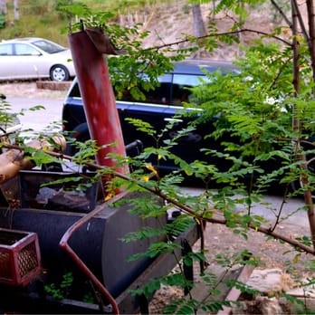 Deep Creek - My car parked next to the some type of tractor. I think it's a part of their decor. - Hotels Near Me - Running Springs, California Deep Creek - My car parked next to the some type of tractor. I think it's a part of their decor. - Hotels Near Me - Running Springs, California